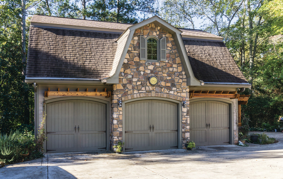 Inspiration for a large traditional detached three-car garage in Atlanta.