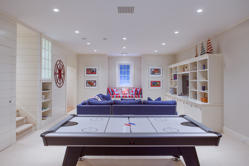 This is an example of a large beach style look-out basement in Boston with white walls, carpet, no fireplace and white floor.