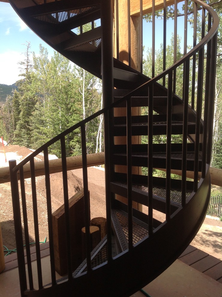 This is an example of a mid-sized modern metal spiral staircase in Salt Lake City with open risers.
