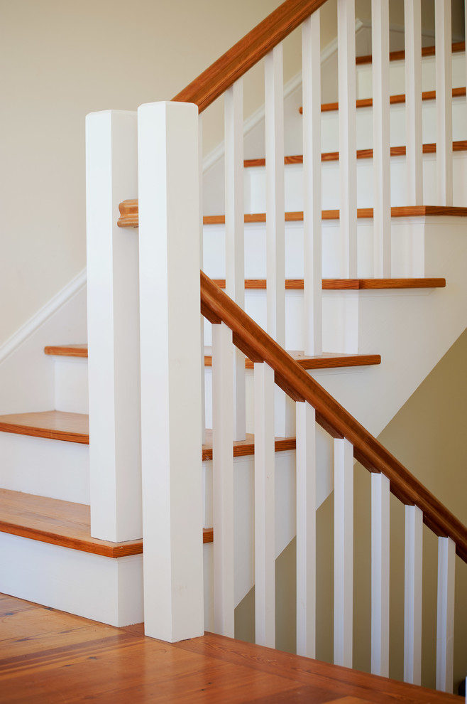 Farmhouse wooden u-shaped staircase photo in Burlington with painted risers