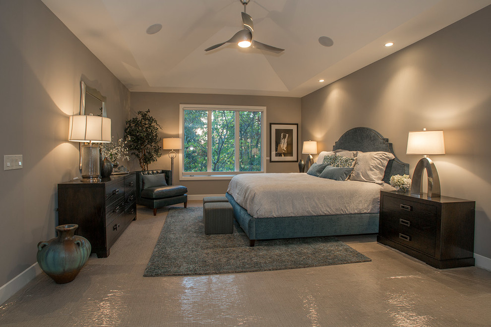 This is an example of a large transitional master bedroom in Cincinnati with grey walls and carpet.