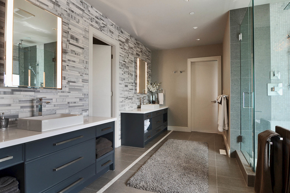 Inspiration for a large modern master bathroom in Vancouver with flat-panel cabinets, blue cabinets, a corner shower, gray tile, matchstick tile, grey walls, cement tiles, a vessel sink, engineered quartz benchtops, grey floor and a hinged shower door.