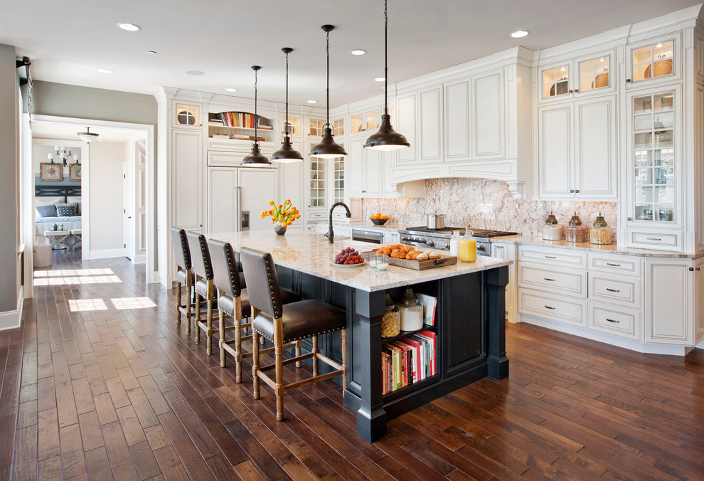 This is an example of a traditional l-shaped kitchen in Philadelphia with raised-panel cabinets, white cabinets, panelled appliances, dark hardwood floors and with island.