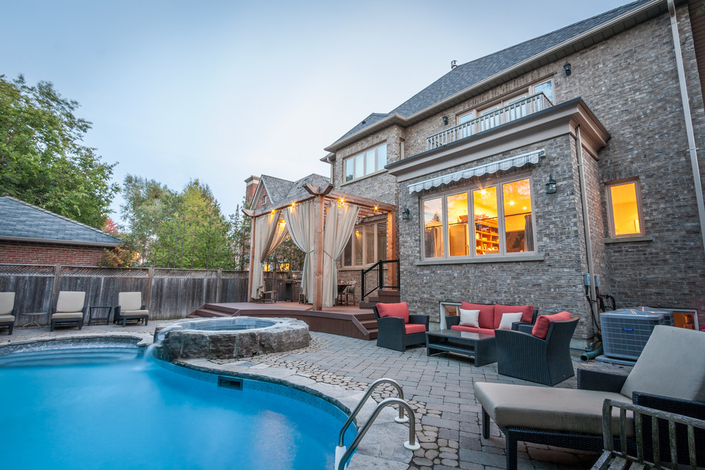 Inspiration for a mid-sized transitional backyard deck remodel in Toronto with a pergola