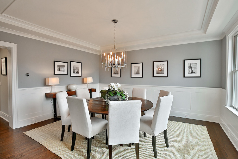 Photo of a transitional dining room in New York with grey walls and dark hardwood floors.