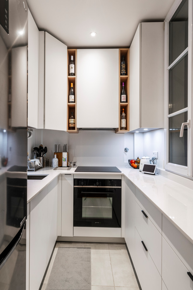Inspiration for a small modern u-shaped separate kitchen in Paris with an integrated sink, quartzite benchtops, white splashback, engineered quartz splashback, black appliances and white benchtop.