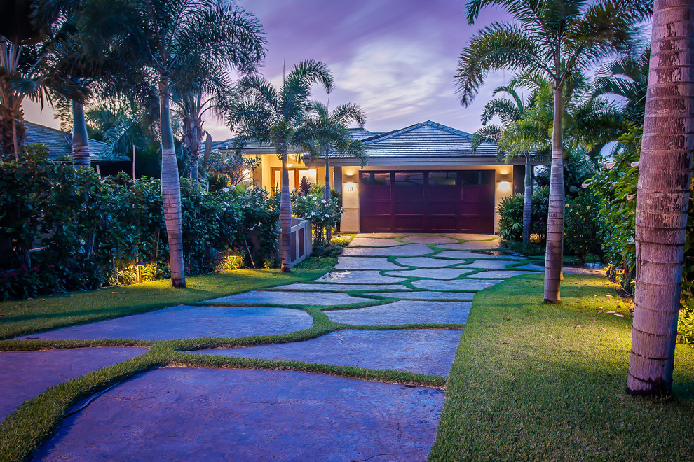 Inspiration for a mid-sized tropical attached two-car garage in Hawaii.