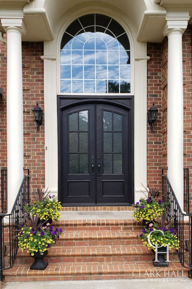 This is an example of a large traditional front door in Charlotte with a double front door and a black front door.