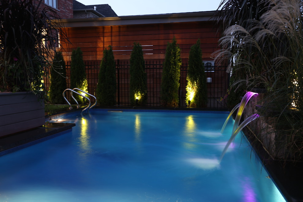 Pool fountain - transitional backyard stone and l-shaped natural pool fountain idea in Toronto