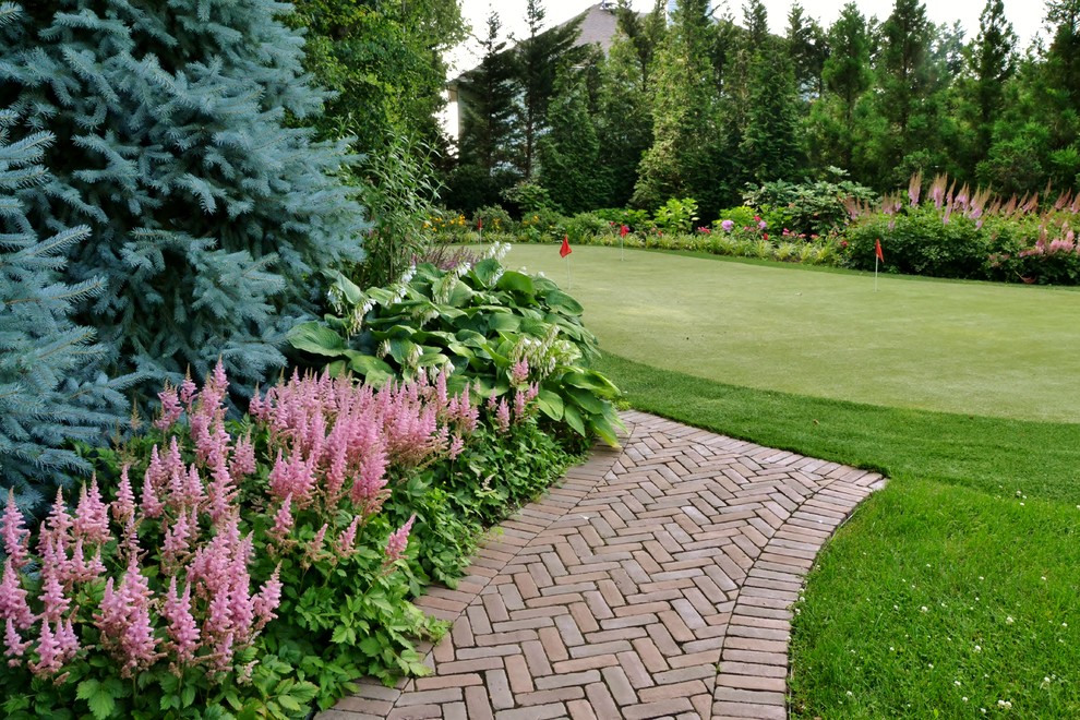 Inspiration for a large tropical side yard partial sun outdoor sport court for summer in New York with concrete pavers.