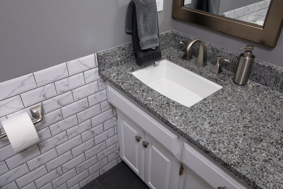 This is an example of a mid-sized contemporary master bathroom in Minneapolis with raised-panel cabinets, white cabinets, an alcove shower, a one-piece toilet, grey walls, an undermount sink, granite benchtops and a shower curtain.