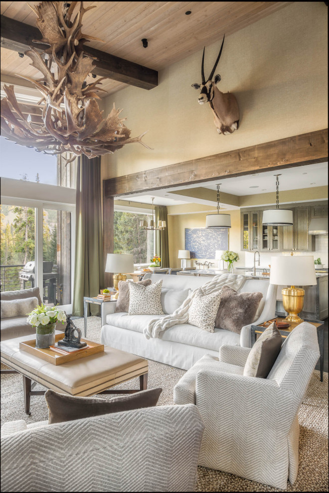 Design ideas for a large country open concept family room in Other with beige walls, dark hardwood floors, a standard fireplace, a stone fireplace surround, a freestanding tv and black floor.