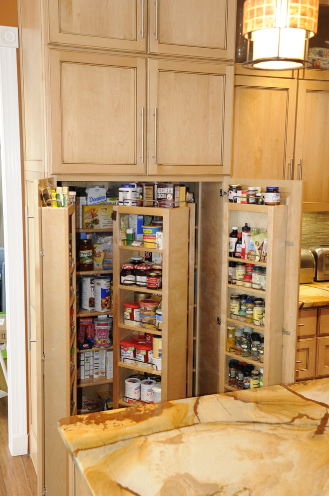 Mid-sized transitional u-shaped light wood floor eat-in kitchen photo in Baltimore with a farmhouse sink, beaded inset cabinets, light wood cabinets, onyx countertops, stainless steel appliances and an island