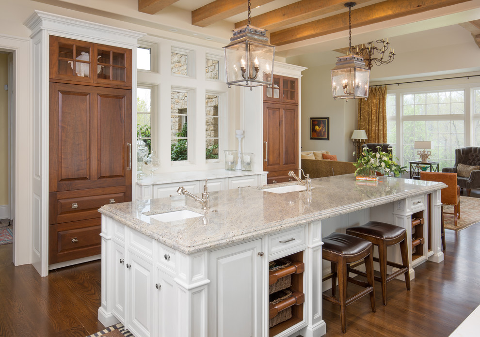 This is an example of a traditional open plan kitchen in Columbus with an undermount sink, raised-panel cabinets, medium wood cabinets, medium hardwood floors and with island.