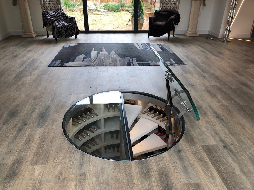Photo of a mid-sized modern wine cellar in Cambridgeshire with limestone floors, storage racks and white floor.