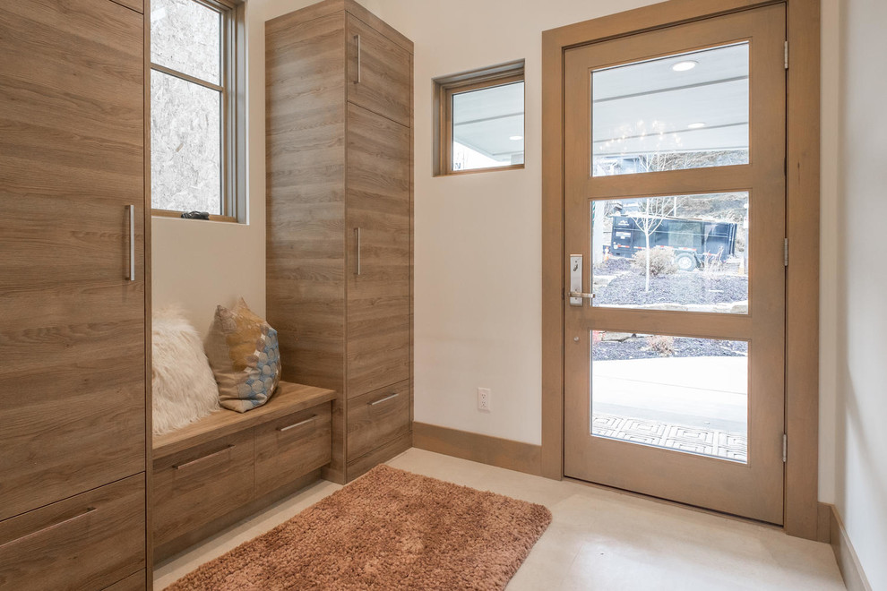 Design ideas for a mid-sized contemporary mudroom in Salt Lake City with white walls, porcelain floors, a single front door, a glass front door and beige floor.