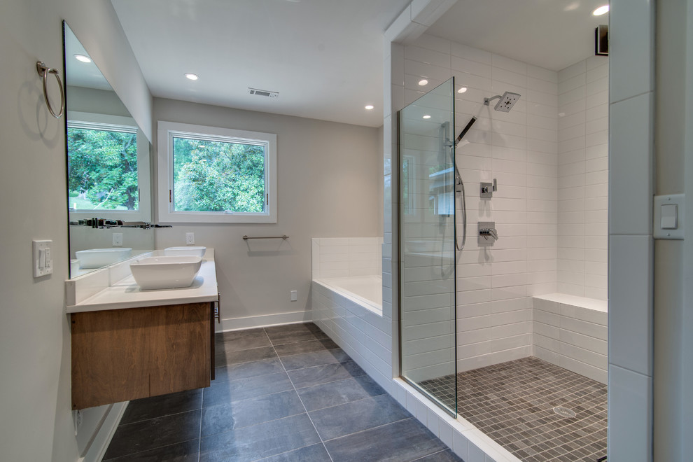 Mid-sized beach style master bathroom in Nashville with a vessel sink, flat-panel cabinets, medium wood cabinets, quartzite benchtops, an open shower, a two-piece toilet, white tile, porcelain tile, grey walls and porcelain floors.