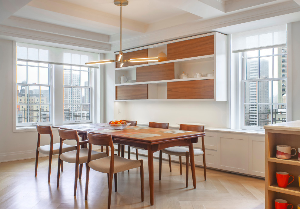 New York City Combination-Renovation - Beautiful open dining room with custom floating wood shelves, a mid-century modern table, and a gorgeous brass pendant over the table.  
New clear finished herringbone floors and cabinets throughout.  White custom base cabinets.
Clean, modern window shades at pre-war windows with amazing views.
The original pre war beamed ceilings are preserved.