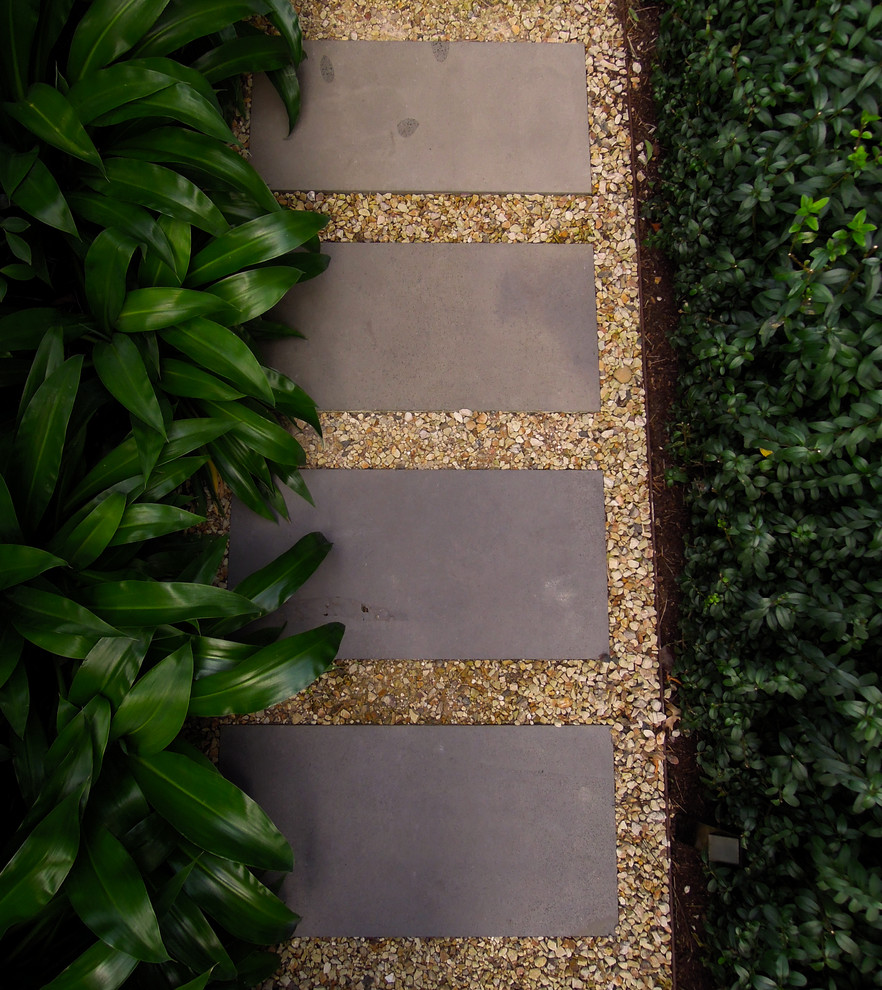 Photo of a large contemporary side yard partial sun garden in Melbourne with a garden path and natural stone pavers.