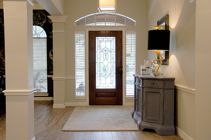 Example of a transitional porcelain tile hallway design in Houston with gray walls