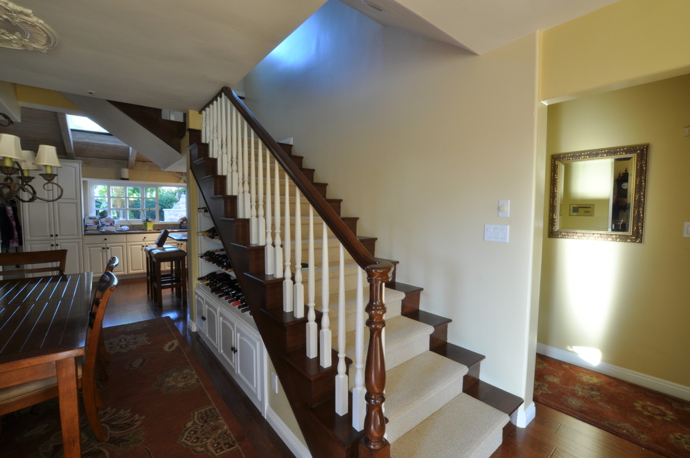 This is an example of a mid-sized traditional wood straight staircase in Los Angeles with wood risers.