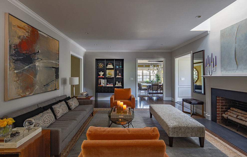 This is an example of a large midcentury formal open concept living room in San Francisco with grey walls, medium hardwood floors, a standard fireplace and a wood fireplace surround.