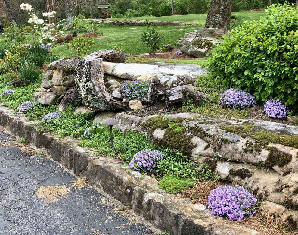 Inspiration for a large traditional hillside driveway in Other.