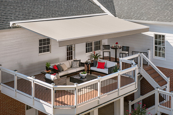Inspiration for a mid-sized backyard patio in Boston with decking and an awning.