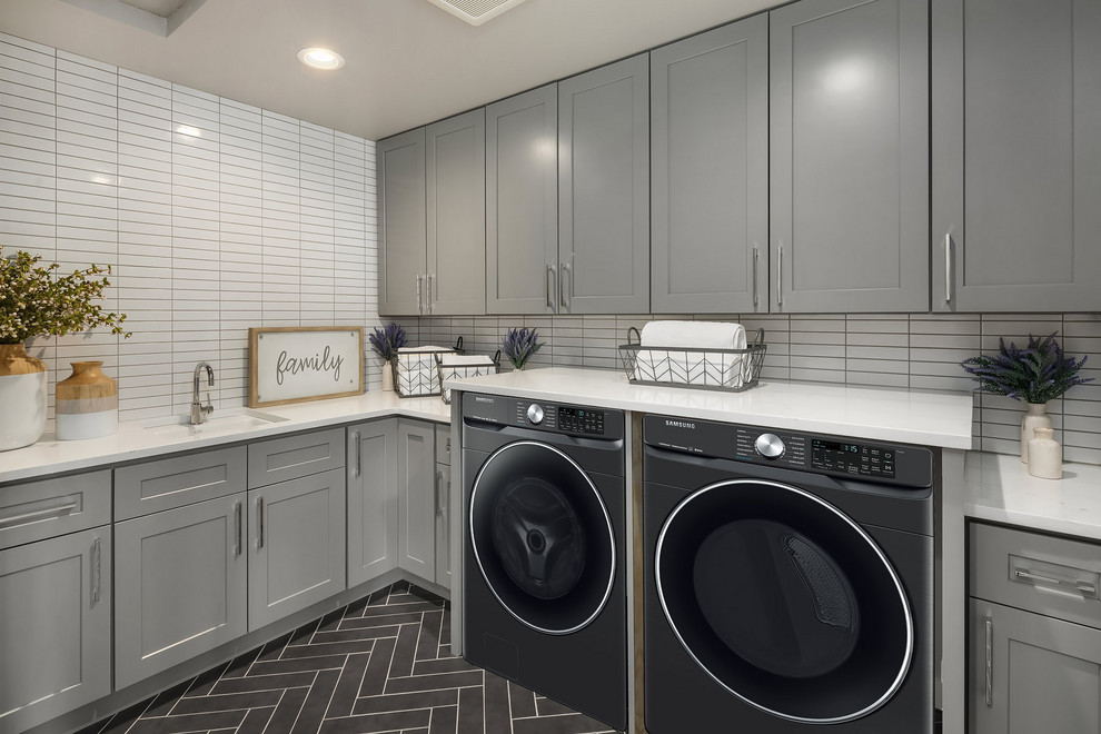 Photo of a country l-shaped laundry room in Seattle with an undermount sink, shaker cabinets, grey cabinets, a side-by-side washer and dryer, grey floor and white benchtop.