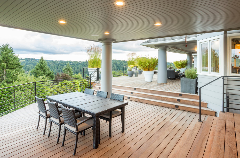 Inspiration for a large transitional backyard deck in Portland with an outdoor kitchen and a roof extension.