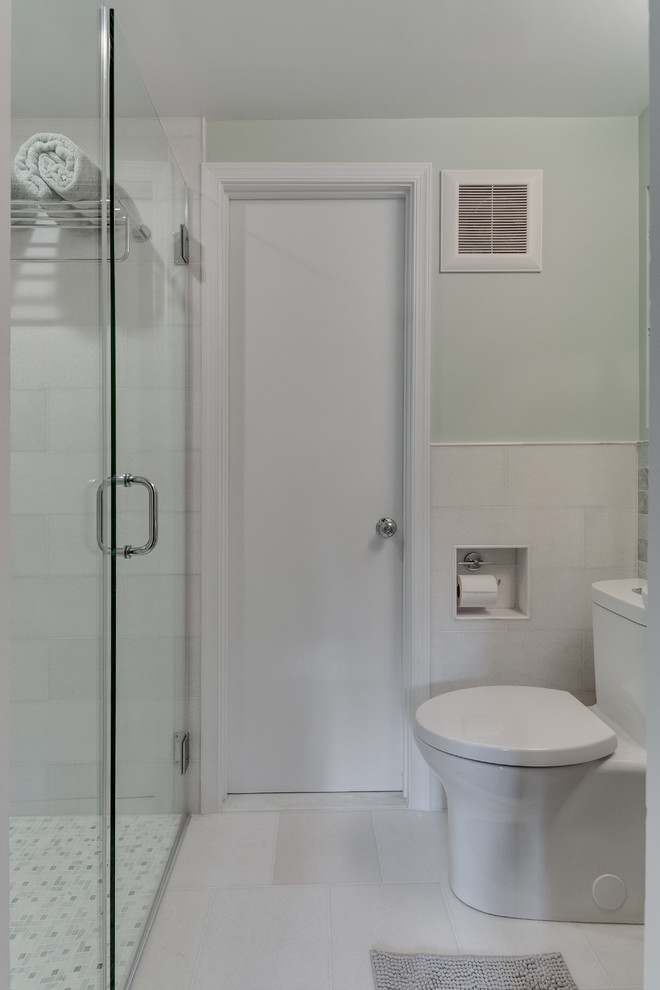 This is an example of a small transitional 3/4 bathroom in DC Metro with an alcove shower, a one-piece toilet, multi-coloured tile, marble, green walls, marble floors, a wall-mount sink, white floor and a sliding shower screen.