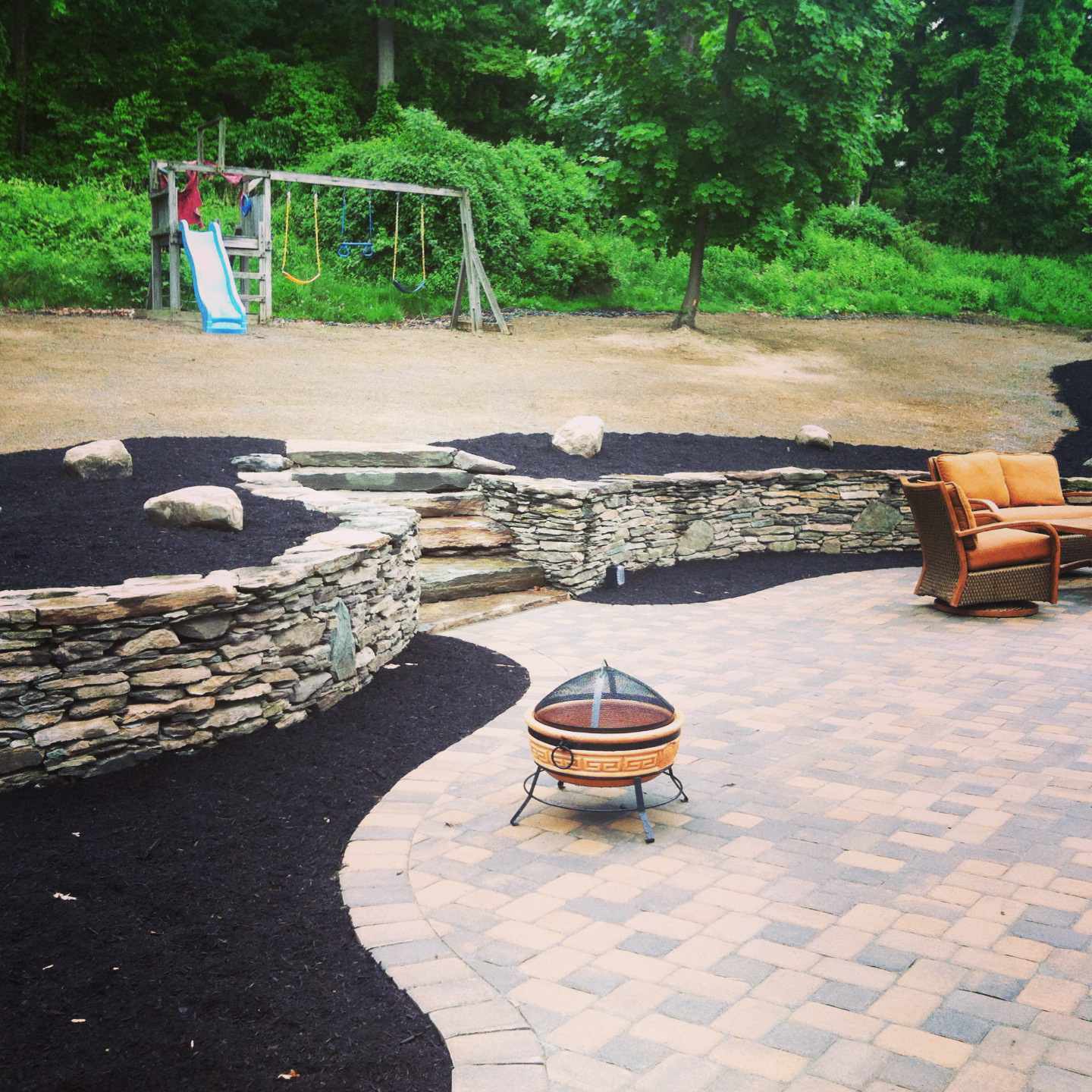 waterfall natural fieldstone walls with two tiered paver patio