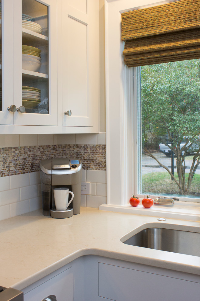 Example of a small transitional u-shaped dark wood floor and brown floor eat-in kitchen design in Raleigh with an undermount sink, recessed-panel cabinets, white cabinets, quartz countertops, white backsplash, subway tile backsplash, stainless steel appliances, no island and beige countertops