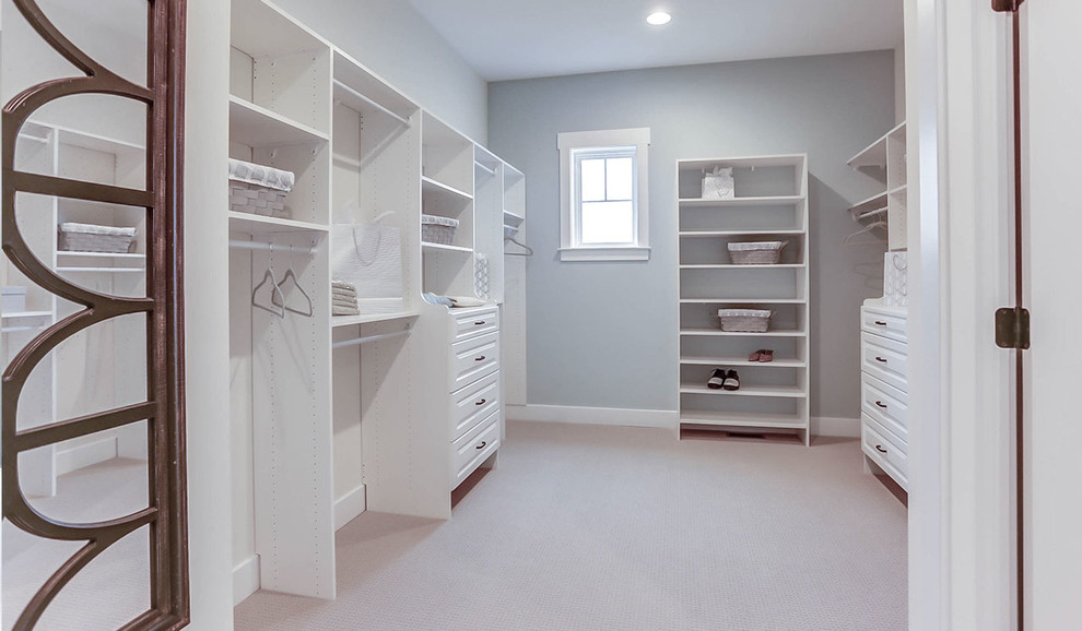 Inspiration for an expansive country walk-in wardrobe in Other with white cabinets, carpet and beige floor.