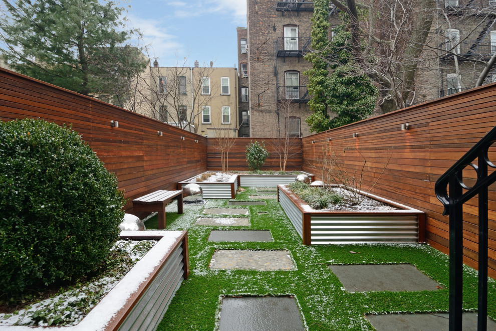 Photo of a small contemporary backyard garden for winter in New York with a container garden.