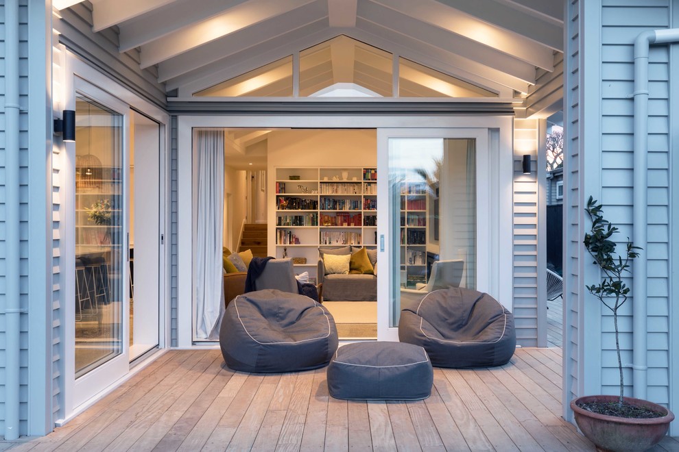 Inspiration for a transitional backyard deck in Auckland with a roof extension.