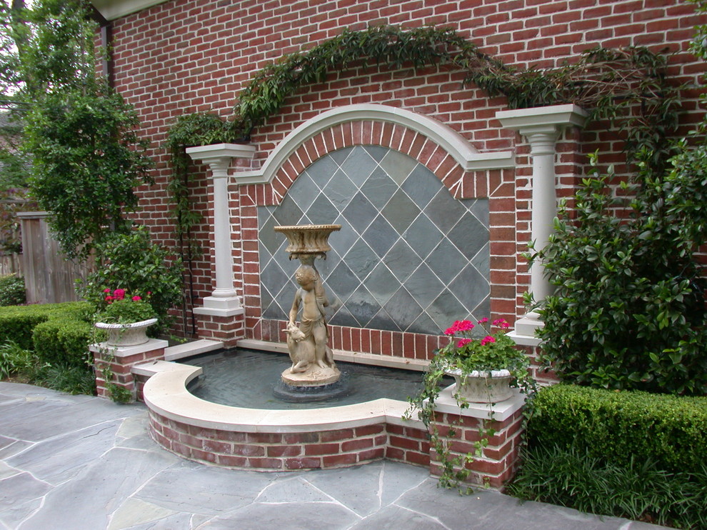 This is an example of a traditional garden in Houston with a water feature.