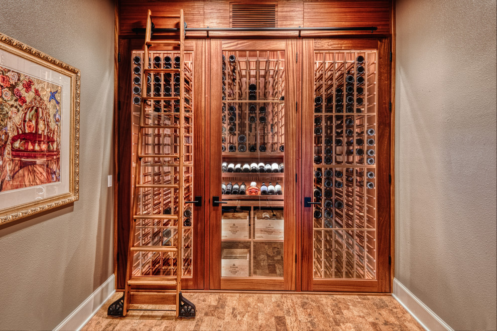 Photo of a small arts and crafts wine cellar in Portland with cork floors and storage racks.