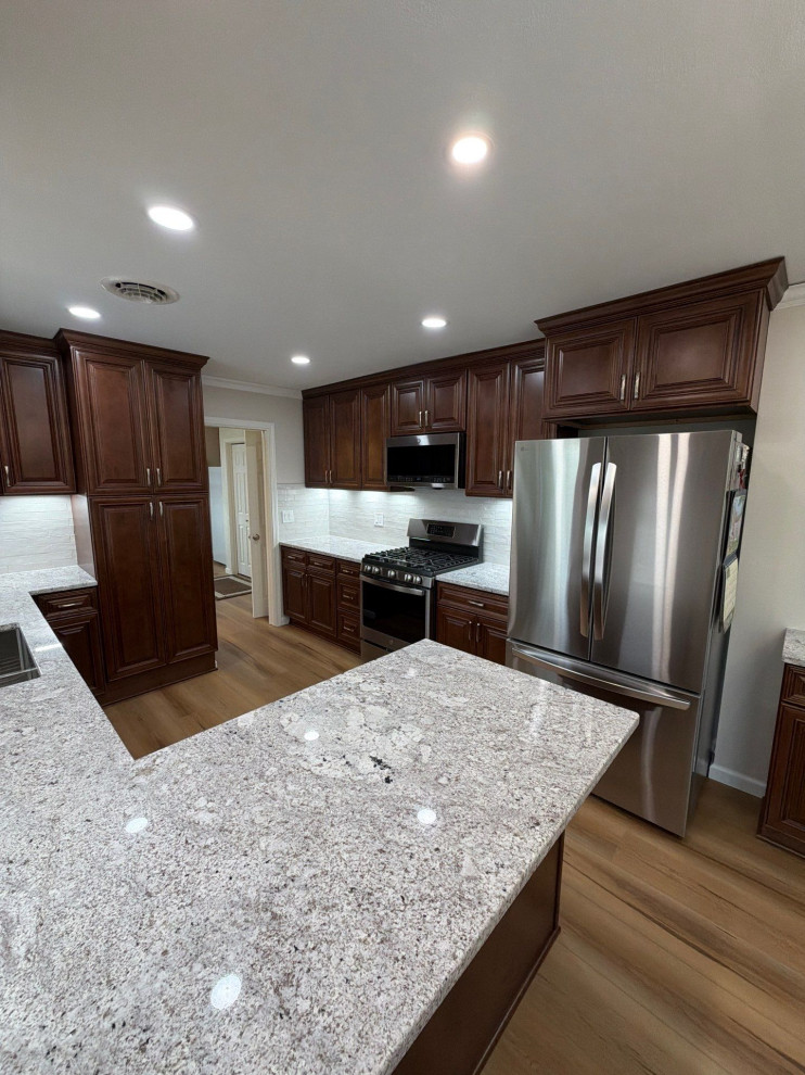 USCD cabinetry accompanied granite countertops, porcelain tile backsplash and Ca