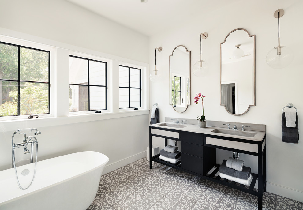 Large transitional master bathroom in New York with black cabinets, a freestanding tub, cement tile, cement tiles, an integrated sink and soapstone benchtops.