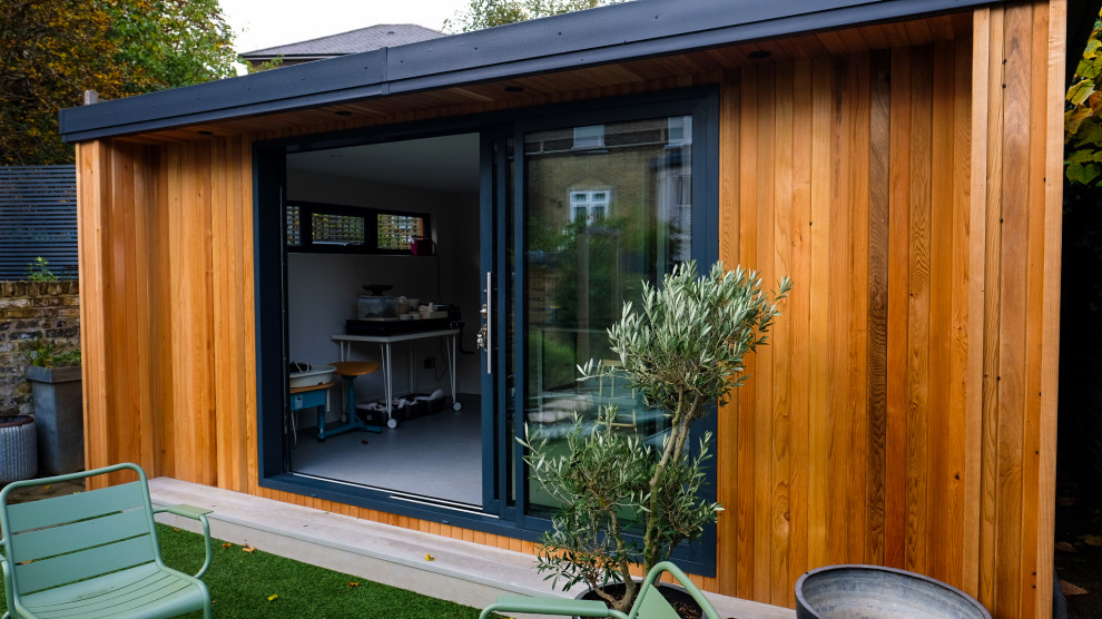 Inspiration for a mid-sized modern detached studio / workshop shed remodel in Surrey