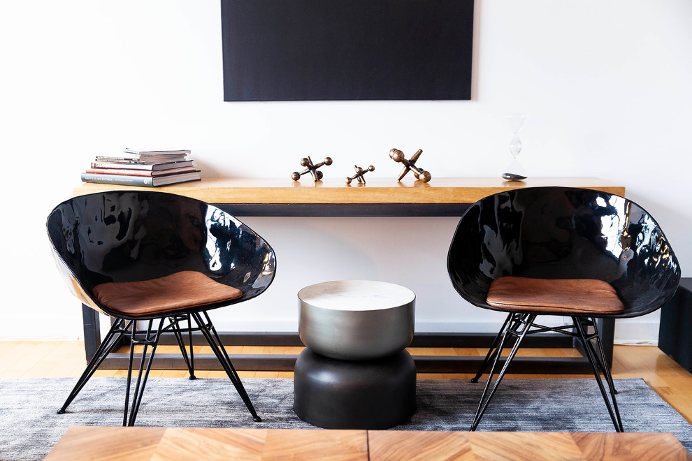 Example of a small urban formal and open concept medium tone wood floor and brown floor living room design in Philadelphia with white walls, no fireplace and a tv stand