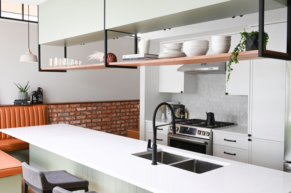 Design ideas for a small contemporary galley eat-in kitchen in Vancouver with an undermount sink, shaker cabinets, green cabinets, quartz benchtops, grey splashback, ceramic splashback, stainless steel appliances, light hardwood floors, with island, beige floor, white benchtop and wood.