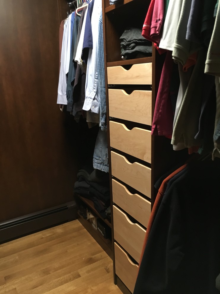 Mid-sized transitional light wood floor walk-in closet photo with open cabinets and dark wood cabinets