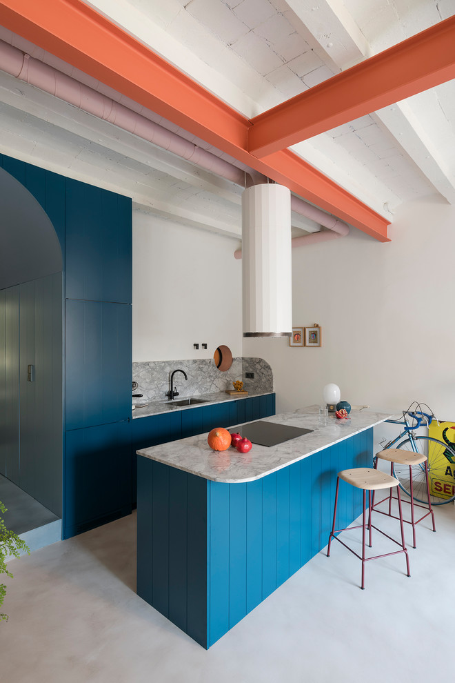 This is an example of an industrial galley kitchen in Barcelona with raised-panel cabinets, turquoise cabinets, grey splashback, panelled appliances, with island, grey floor and grey benchtop.