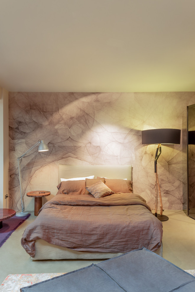 This is an example of a contemporary master bedroom in Bologna with wallpapered walls.