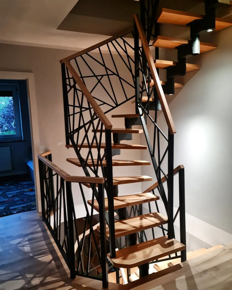 Mid-sized urban wooden spiral metal railing staircase photo in Moscow with wooden risers
