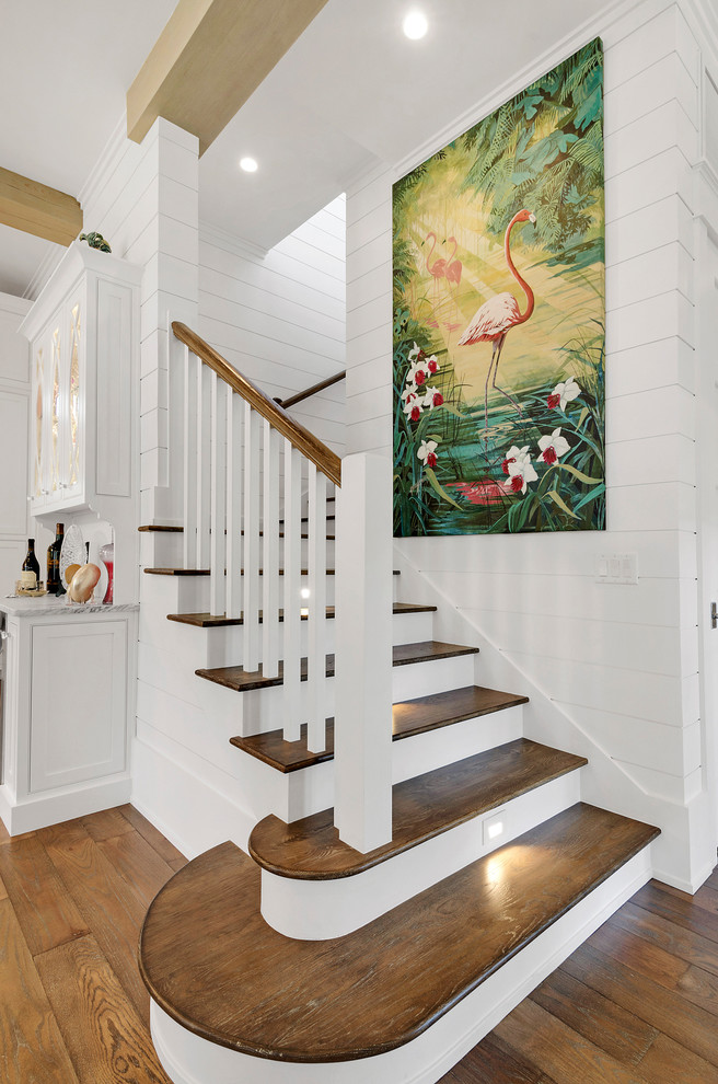 Photo of a beach style wood staircase in Miami with painted wood risers.