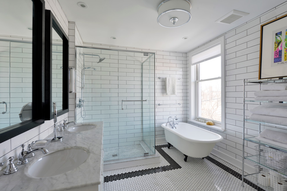 Photo of a mid-sized transitional master bathroom in Ottawa with recessed-panel cabinets, white cabinets, white tile, marble benchtops, a claw-foot tub, an alcove shower, a one-piece toilet, ceramic tile, white walls, ceramic floors and an undermount sink.