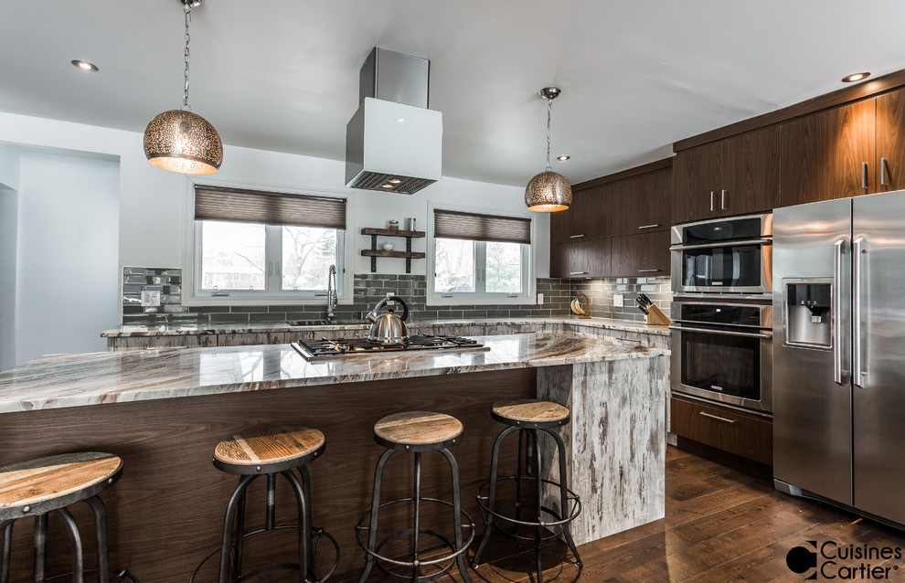 Design ideas for an expansive contemporary galley eat-in kitchen in Montreal with an undermount sink, flat-panel cabinets, medium wood cabinets, granite benchtops, green splashback, subway tile splashback, stainless steel appliances, dark hardwood floors and with island.